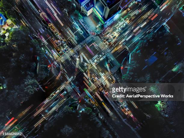 drone point view of city street crossing at rush hour - illuminated stock pictures, royalty-free photos & images
