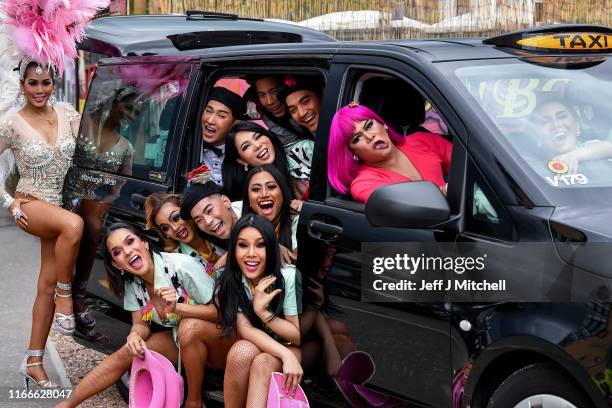 The cast of the Lady Boys of Bangkok squeeze into a taxi during a fundraising event for Edinburgh taxi drivers children’s charities on August 7, 2019...