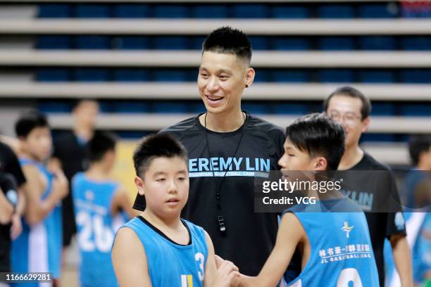 Player Jeremy Lin of the Toronto Raptors plays basketball with children during a basketball camp at Nansha gymnasium on August 7, 2019 in Guangzhou,...