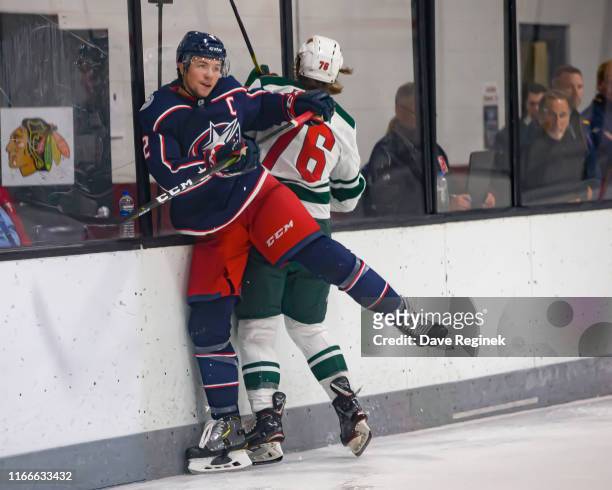 Andrew Peeke of the Columbus Blue Jackets body checks Sam Bitten of the Minnesota Wild during Day-2 of the NHL Prospects Tournament at Centre Ice...