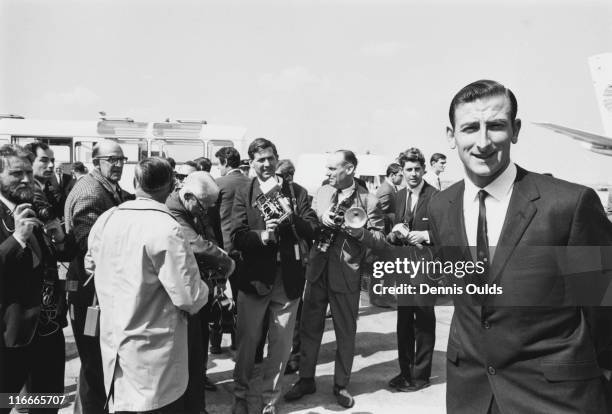 Australian cricket captain Bill Lawry , surrounded by photographers as he arrives with the rest of the Australian touring team, at Heathrow Airport,...