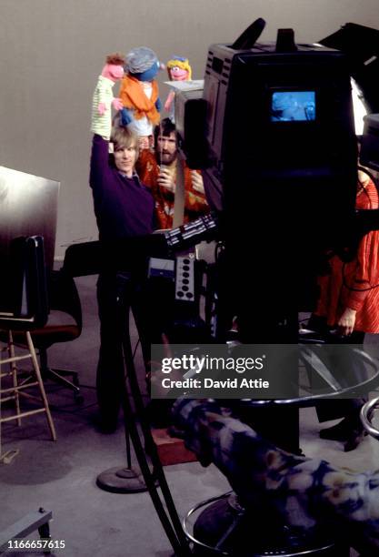 Puppeteers Daniel Seagren holding Roosevelt Franklin, Jim Henson holding Grandmother Happy and Frank Oz with Betty Lou tape an episode of Sesame...