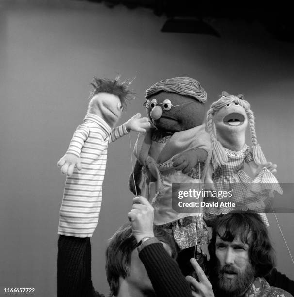 Puppeteers Daniel Seagren holding Roosevelt Franklin, Jim Henson holding Grandmother Happy and Frank Oz with Betty Lou tape an episode of Sesame...