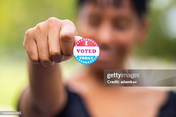 young black woman with i voted sticker - democratic party united states stock pictures, royalty-free photos & images