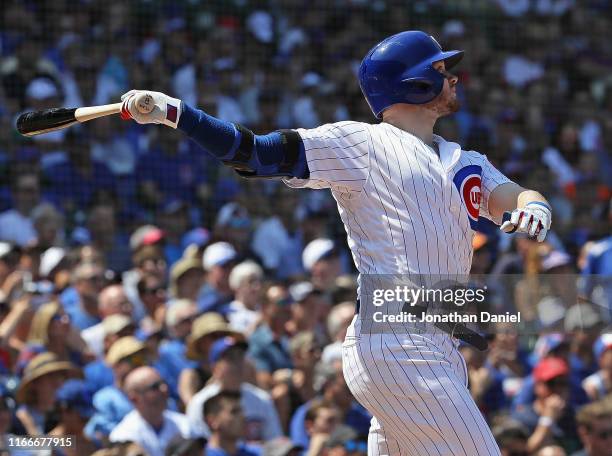 Ian Happ of the Chicago Cubs hits a grand slam home run in the 4th inning against the Oakland Athletics at Wrigley Field on August 07, 2019 in...