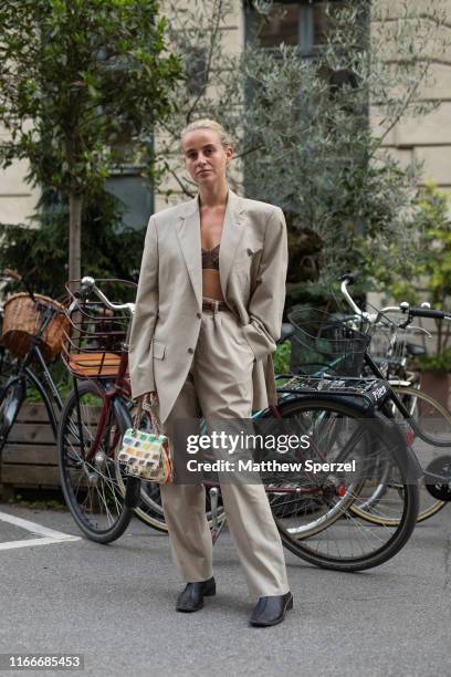 Guest is seen on the street attending Copenhagen Fashion Week SS20 wearing taupe blazer and pants, rainbow hand bag on August 07, 2019 in Copenhagen,...