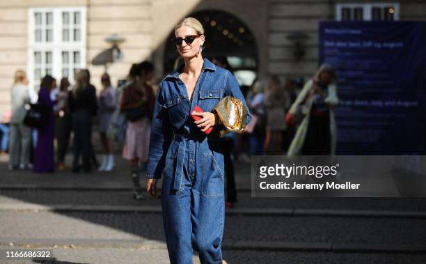 Fashion Week guest a jeans overall on August 07, 2019 in Copenhagen, Denmark.
