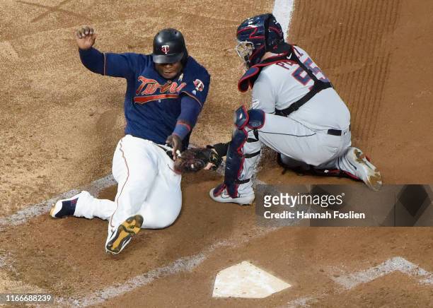 Roberto Perez of the Cleveland Indians defends home plate against Miguel Sano of the Minnesota Twins during the fourth inning of the game at Target...
