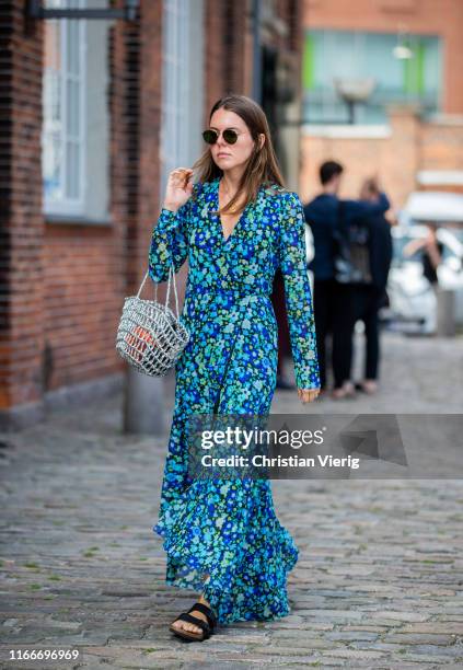 Guest is seen wearing dress with floral print outside Rodebjer during Copenhagen Fashion Week Spring/Summer 2020 on August 07, 2019 in Copenhagen,...