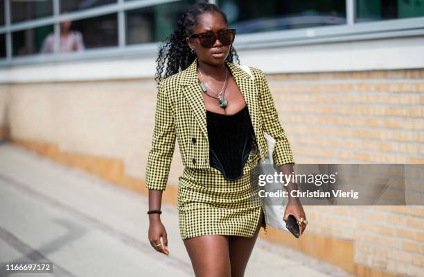 Guest is seen outside Holzweiler during Copenhagen Fashion Week Spring/Summer 2020 on August 07, 2019 in Copenhagen, Denmark.