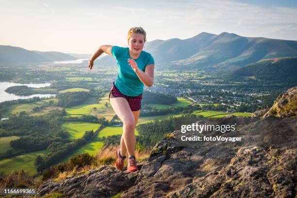 woman trail runner bounding up rocky mountain summer summit - keswick stock pictures, royalty-free photos & images