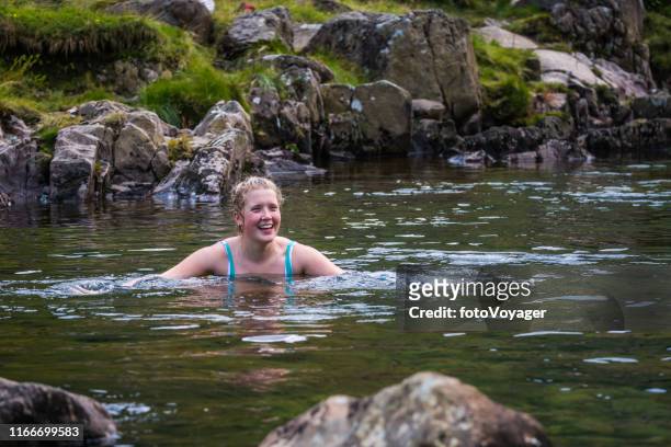 wild swimming woman in clear mountain stream lake district cumbria - uncultivated stock pictures, royalty-free photos & images