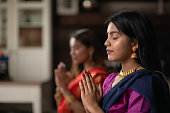 Indian Females Praying One Afternoon in Their Living Room