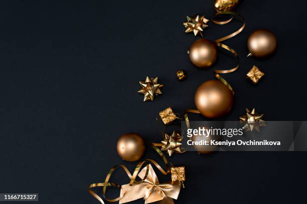 beautiful christmas golden silver deco baubles on dark black background. flat lay design. copy space. horizontal. - christmas decoration stock pictures, royalty-free photos & images