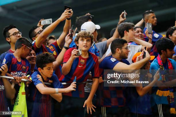 Barcelona fans take photos prior to the game between SSC Napoli and FC Barcelona during a preseason friendly match at Hard Rock Stadium on August 07,...