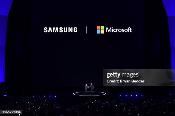 Samsung President & CEO DJ Koh and Microsoft CEO Satya Narayana Nadella greet onstage during Samsung Unpacked New York City at Barclays Center at...