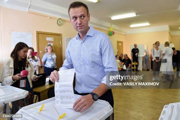 Russian opposition activist Alexei Navalny casts his vote at a polling station during to the Moscow city Duma election in Moscow on September 8,...