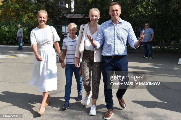 Russian opposition activist Alexei Navalny , his daughter Daria , son Zakhar and wife Yulia arrive at a polling station during to the Moscow city...
