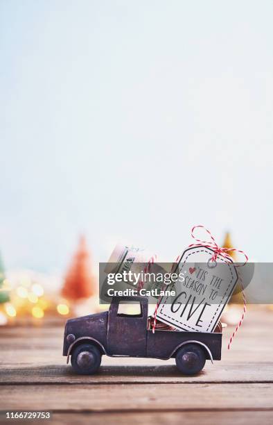 season to give. truck carrying roll of dollars with holiday background - 50 dollar bill stock pictures, royalty-free photos & images