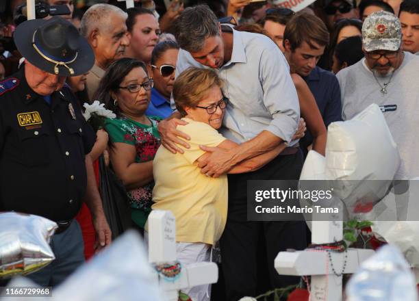 Democratic presidential candidate and former Rep. Beto O’Rourke hugs a woman at a makeshift memorial outside Walmart honoring victims of a mass...