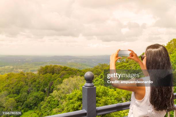 stylish young woman taking pictures at montville, sunshine coast, australia - sunday in the valley stock pictures, royalty-free photos & images