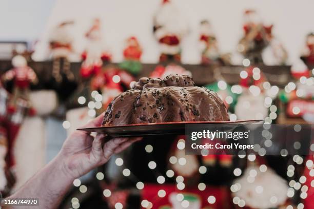 woman hands holding pannetone in christmas time at home - christmas cake fotografías e imágenes de stock