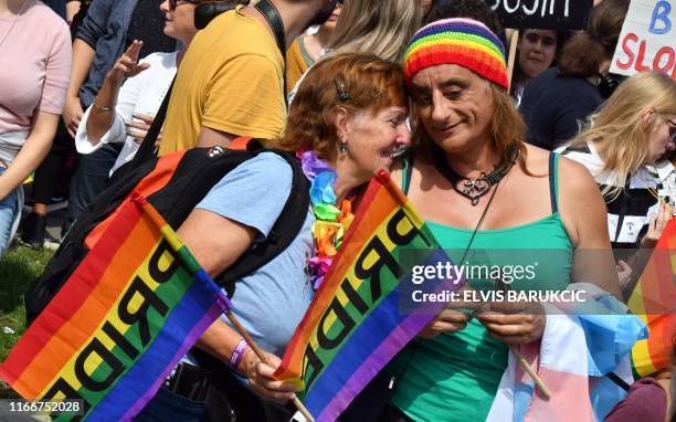 Activists hold rainbow flags as they march through Sarajevo city centre, on September 8 during Bosnia-Herzegovina's first-ever Gay Pride parade. -...