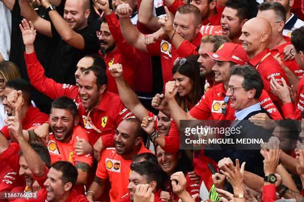 Winner Ferrari's Monegasque driver Charles Leclerc and Ferrari CEO Louis C. Camilleri celebrate with team members after the Italian Formula One Grand...