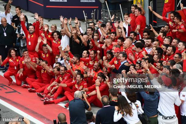 Winner Ferrari's Monegasque driver Charles Leclerc celebrates with Ferrari CEO Louis C. Camilleri, Ferrari team principal Mattia Binotto and other...