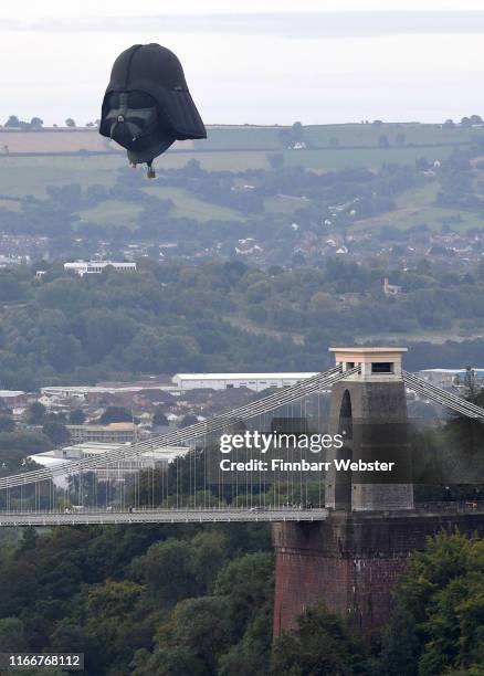 Darth Vader balloon above Clifton Suspension Bridge during the hot air balloons mass ascent at sunrise on the first day of the Bristol International...