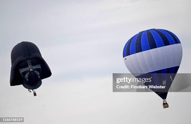 Hot air balloons take to the skies as they participate in the mass ascent at sunrise on the first day of the Bristol International Balloon Fiesta on...