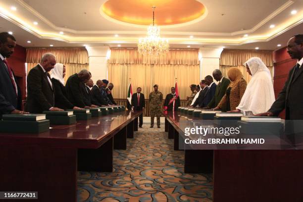 Members of the Sudanese cabinet take oath in the presence of the new Prime Minister Abdalla Hamdok and General Abdel Fattah al-Burhan, the head of...