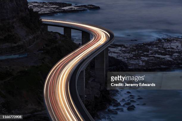 traffic on bridge - illuminated stock pictures, royalty-free photos & images