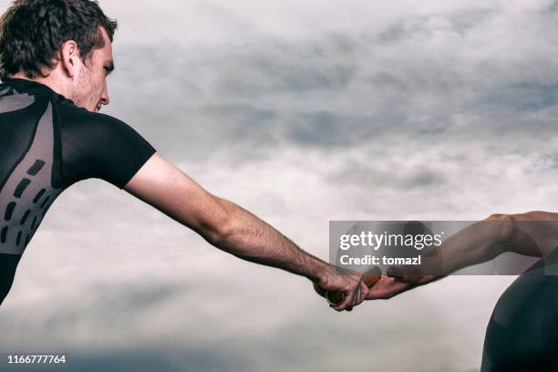 relay baton exchange - passing sport stock pictures, royalty-free photos & images