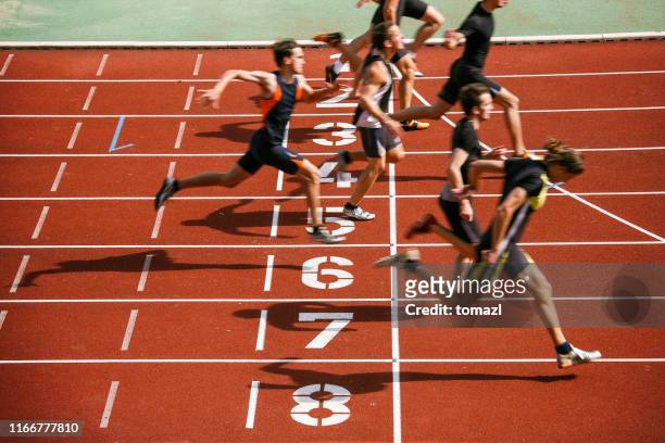 athlets sprinting at finish line - sports race stock pictures, royalty-free photos & images