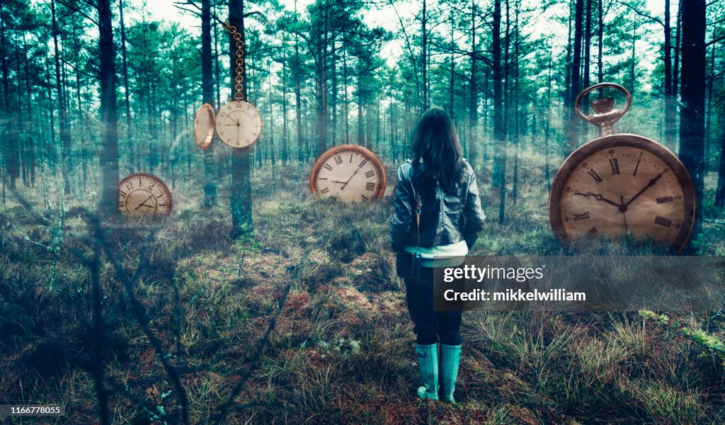 Concept of time with woman in forest surrounded by big clocks