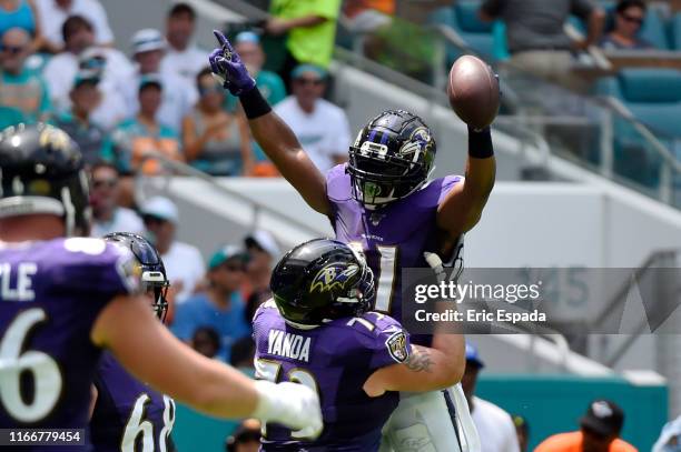 Mark Ingram of the Baltimore Ravens celebrates after scoring a touchdown in the first quarter against the Miami Dolphins at Hard Rock Stadium on...