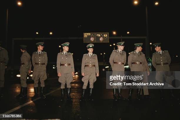 East German border guards on duty at Checkpoint Charlie on Friedrichstrasse on the night the border between East and West Berlin was opened, 10th...
