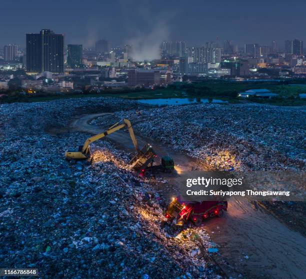 aerial view waste management with cityscape background at dusk for environment reservation. - nuclear waste management stock pictures, royalty-free photos & images