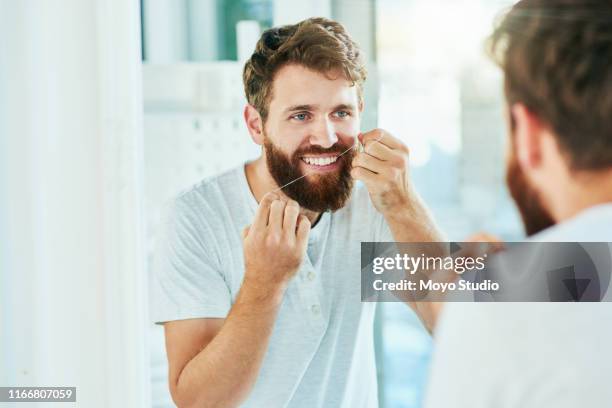 floss für gesündere zähne - zahnseide stock-fotos und bilder