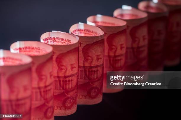 chinese one hundred yuan banknotes on black background - yuan symbol stock-fotos und bilder