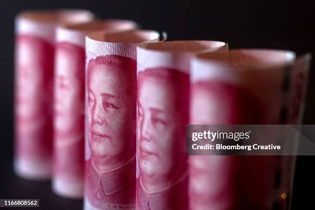 chinese one hundred yuan banknotes on black background - yuan symbol stock-fotos und bilder