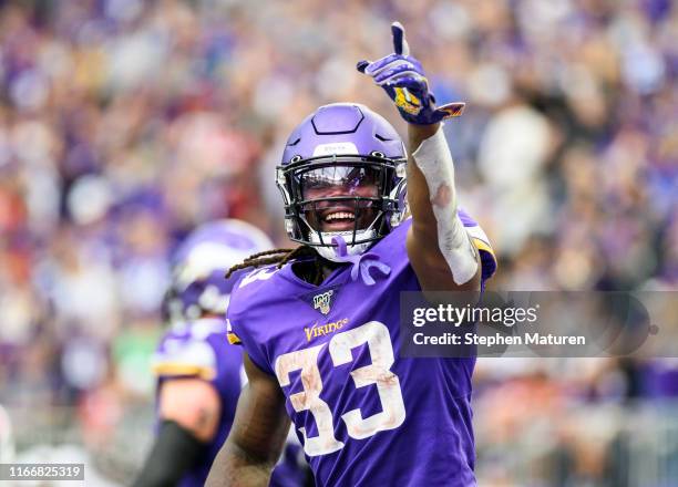 Dalvin Cook of the Minnesota Vikings points to the crowd after scoring a touchdown in the third quarter of the game against the Atlanta Falcons at...