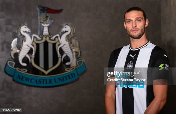 Andy Carroll poses for photographs with the club crest at St.James' Park during a photocall on August 08, 2019 in Newcastle upon Tyne, England.