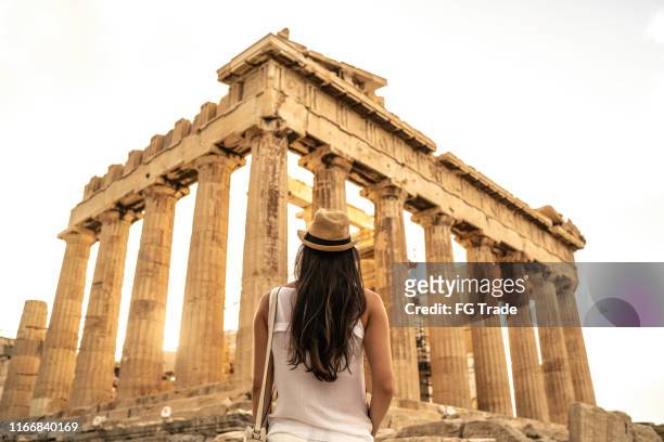 rear view of a young woman admiring the pathernon, athens - acropolis athens stock pictures, royalty-free photos & images