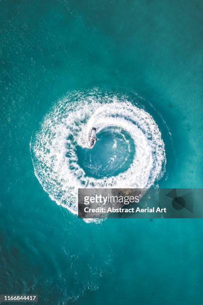 Drone shot of a jet ski making circle patterns at sea, Barbados