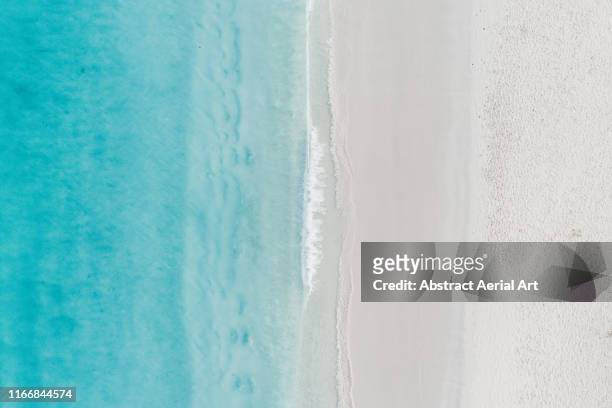 tranquil aerial shot of the ocean and a beach, barbados - wasserrand stock-fotos und bilder