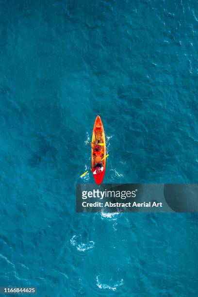 single kayak in the ocean, barbados - kayak stock pictures, royalty-free photos & images