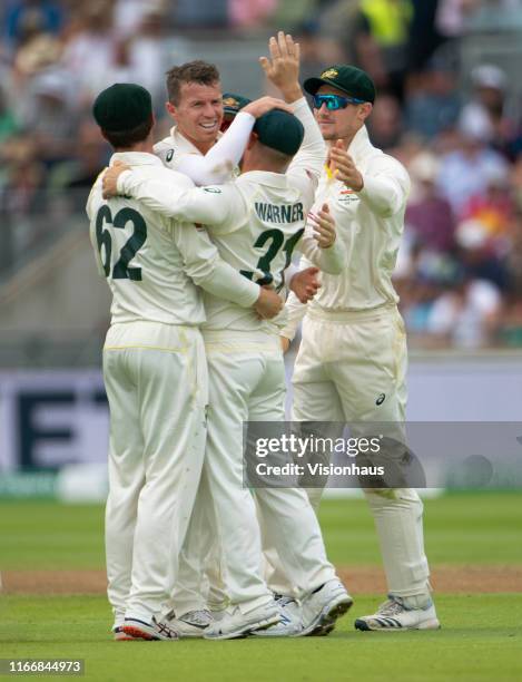 Peter Siddle of Australia celebrates with team mates after taking the wicket of Jonny Bairstow of England during day three of the First Ashes test...