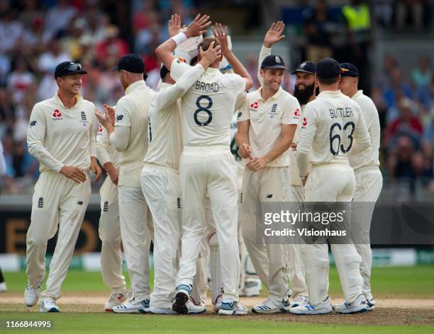 The England team celebrate as Stuart Broad takes the wicket of David Warner of Australia during day three of the First Ashes test match at Edgbaston...